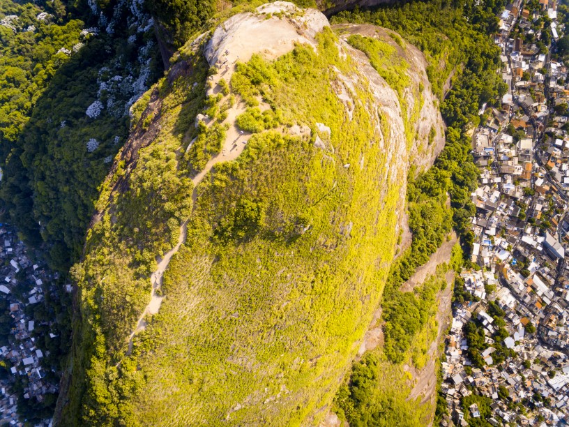 Rad aerial shot of Dois Irmãos with Vidigal favela on the right, and Rochina favela on the left. 